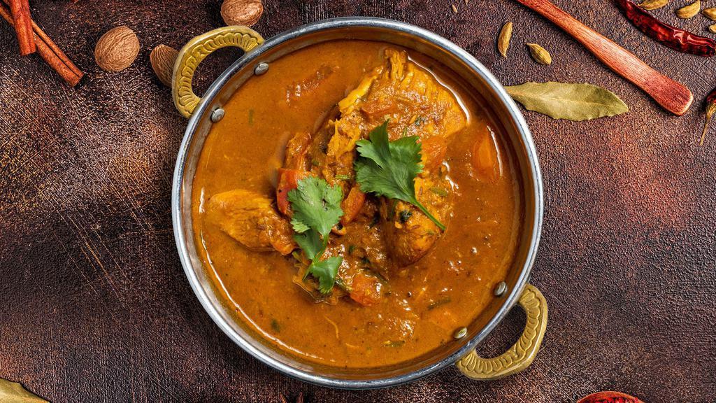 Curry Kinship · Your choice of protein cooked in a tomato-based onion gravy with freshly ground spices.