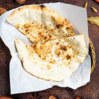 Naan Negotiable Bread · Oven loving with freshly baked bread in a clay oven.