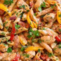 Cajun Chicken Pasta · Penne noodles with a spicy cream sauce, grilled chicken & garlic roasted red bell peppers to...