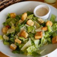 Caesar Salad · Romaine lettuce toassed in Caesar dressing, shaved Grana Padano cheese and homemade croutons.