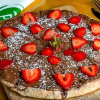 Fresa Y Chocolate Pizza* · Nutella spread, strawberries and powdered sugar.