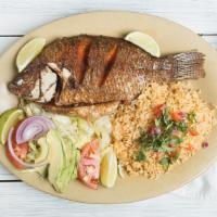 Mojarra · Fried tilapia served with rice and salad.
