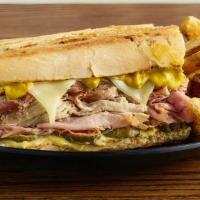 The Cuban Panini · Our awesome Cuban sandwich - Smoked pork, ham, swiss, pickles, and mustard on real Cuban bre...