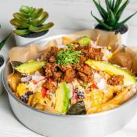Mexican Nachos · Corn tortilla chips, melted Mexican cheese, black beans, roasted corn, avocado, chipotle cre...