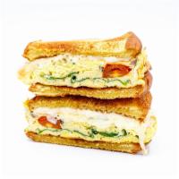 Eggstatic Breakfast Sandwich · Egg, Spinach, Onions, Tomatoes, and Cheese.