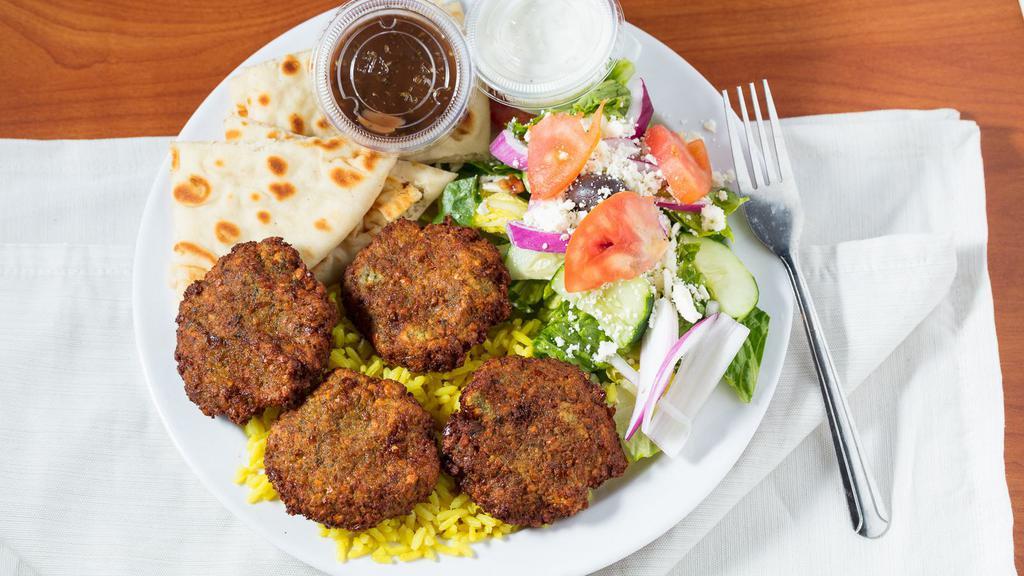 Falafel Plate · Fried ground chickpeas with herbs. Served over rice with a side greek salad & pita and tahini sauce.