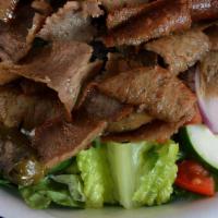 Gyro Salad · Lamb gyro on greek salad with greek balsamic dressing, homemade tzatziki and pita bread.