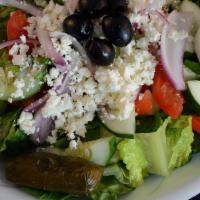 Greek Salad · Romaine & iceberg lettuce, tomatoes, cucumbers, olives, onions, stuffed grape leaf and feta ...