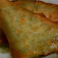 Spanakopita (2) · Filo pastry triangles filled with spinach & feta cheese.