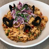 Arroz Con Mariscos · Peruvian fisherman rice, made with squid, shrimp and mussels, topped with salsa criolla