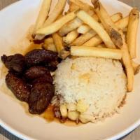 Kid Lomito Saltado · Beef tenderloin stir-fry, rice with Peruvian corn, soy & oyster sauce. Served with French fr...
