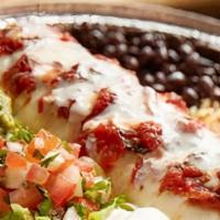 Baja Queso Burrito · Chicken or steak, Monterey Jack cheese, sautéed peppers and onions. Grilled and smothered ch...