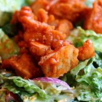 Hot Chicken Salad · Yummy hot chicken salad on a bed of romaine lettuce, tomatoes, onions, mixed cheeses and cro...