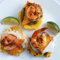 Tostones Veracruz · Golden fried plantains prepared three ways: guacamole, refried beans, and homemade cabbage s...