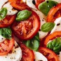 Caprese · Italian salad, made of sliced fresh mozzarella, tomatoes and sweet basil, seasoned with salt...