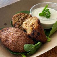 Kibbeh · a fried organic pocket of  wheat  dough stuffed with meatless crumble and served with a side...