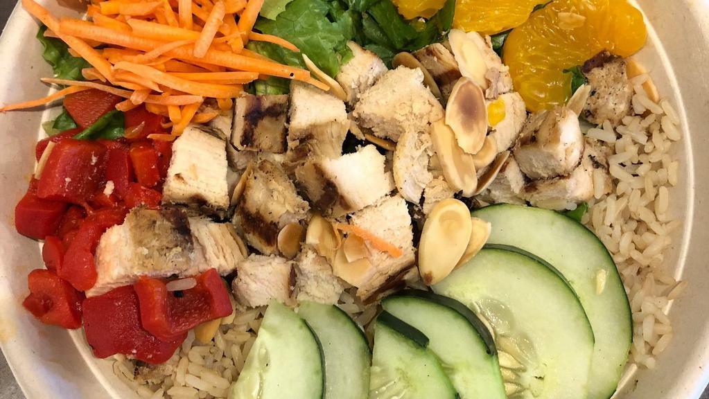 Asian Inspired Grain Bowl · Brown rice, lettuce, Mandarin oranges, roasted red peppers, shredded carrots, cucumber, fresh chicken, and almonds.  Served with Asian Sesame dressing.