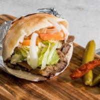 Gyro Sandwich · Gyro marinated meat slow-roasted to perfection, stuffed in a fresh pita pocket topped with t...