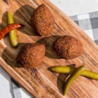 Kibbeh (1 Piece) · Deep-fried ground beef balls stuffed with onions and spices.