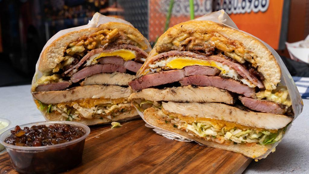 Mixta (Dos Proteínas) / Mixed (Two Proteins) · 2 types of meat of your choice accompanied with stick potatoes, tomatoes, lettuce, coleslaw, egg, American cheese, ham, salami, bacon, ketchup, and garlic sauce.