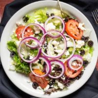 Classic Greek Salad · Anchovies and feta cheese, served with black olives over fresh hand-chopped field greens wit...