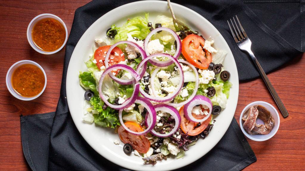 Classic Greek Salad · Anchovies and feta cheese, served with black olives over fresh hand-chopped field greens with red onions, tomatoes, and Fletcher's house Italian dressing.