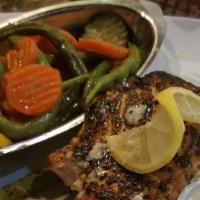 Fresh Char-Grilled Salmon · Fresh char grilled salmon filet dressed in cream sauce with one side.