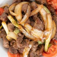 Shaking Beef · Prime steak cuts sautéed in savory sauce with tomatoes, onions & scallions, served w/ side o...