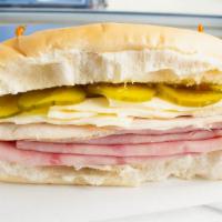 Sandwich Cubano / Cuban Sandwich · Pan cubano, jamón, carne de cerdo, queso y pepinillos. / Cuban bread, ham, pork, cheese, and...
