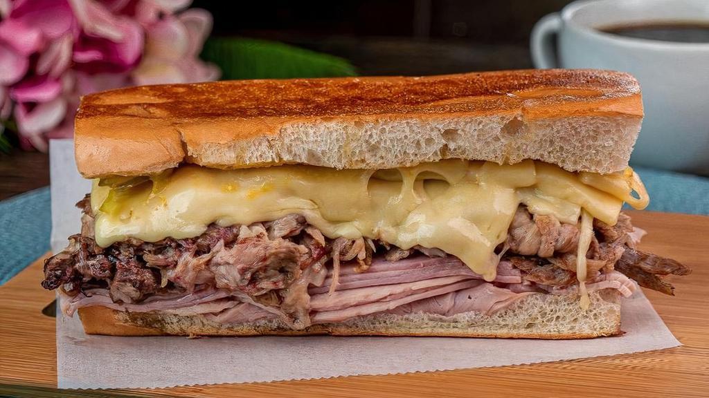 Cuban Sandwich · A Cuban classic served with ham, roasted pork, swiss cheese, pickles, and mustard. Served in perfectly pressed Cuban bread