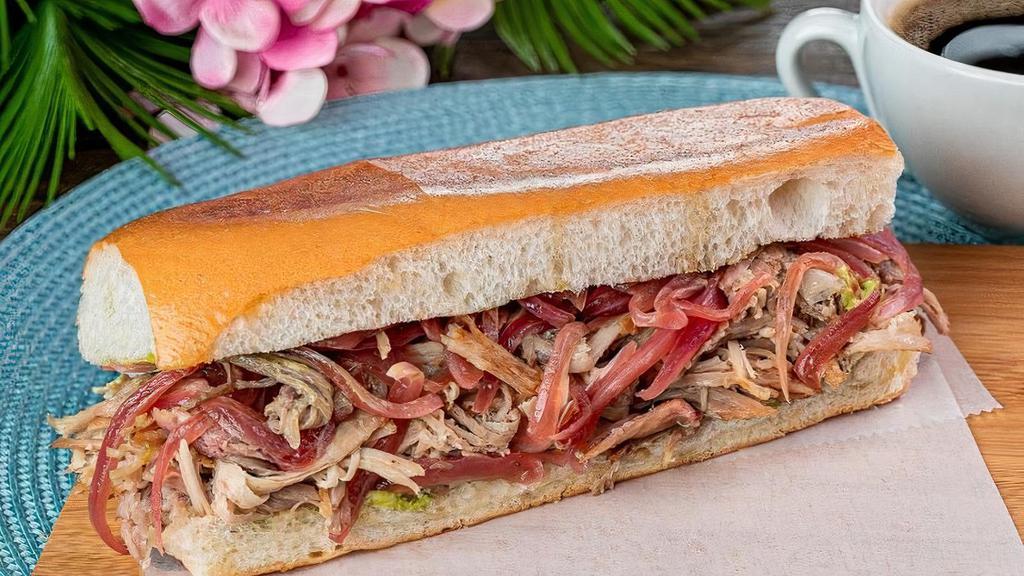 Pan Con Lechon Sandwich · Roasted pork with grilled onions served in pressed Cuban bread
