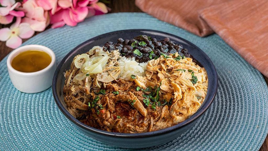 Cuban Sampler Bowl · Taste the 3 most traditional Cuban meat in one bowl: Lechon Asado, Braised and Shredded Flank Steak & Roasted Chicken. Served with White Rice, Black Beans & Mojo Vinaigrette