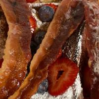 French Toast Delight · Served with strawberries, blueberries, powder sugar and bacon