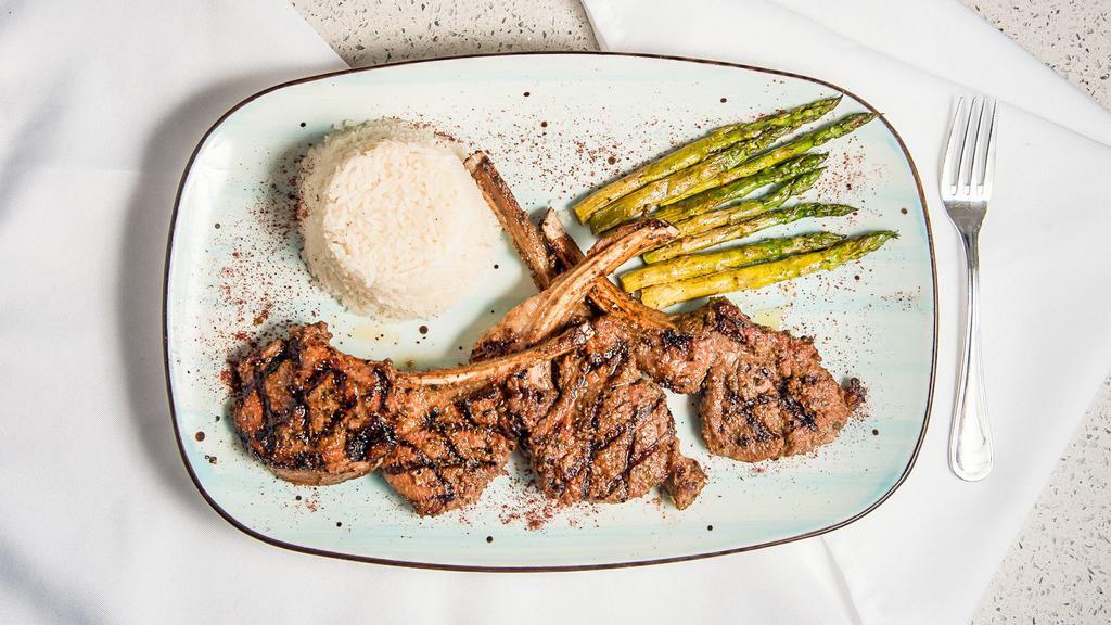 Lamb Chops · 13 oz. premium cut four pieces of rack of lamb delicately marinated and char-grilled, served with baked asparagus and basmati rice.