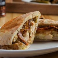 Garlic Aioli Chicken · Pocket bread with chicken Swiss cheese, caramelized onions, and bacon.