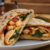 Tuscan Chicken · Pocket bread with chicken, sautéed spinach, sliced tomatoes, roasted garlic, and sun-dried t...