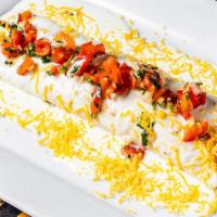 Burrito À La Mexicana · Large grilled tortilla wrapped in rice and beans with your choice of grilled steak or chicke...