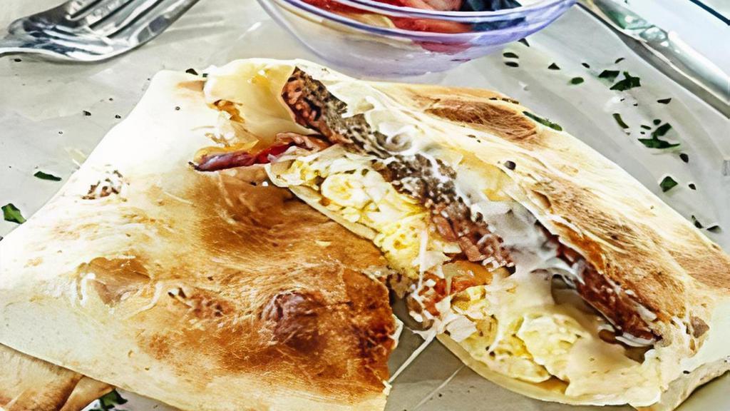 Breakfast Pillow · Scrambled eggs, sausage, bacon, cheese, spread creamy mayonnaise wrapped inside organic tortilla served with side of fruits.