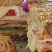 Smoked Turkey · Creamy mayonnaise, smoked turkey, tomatoes, lettuce and swiss cheese garnished with chips or...