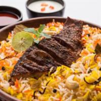 Fish Biryani · Fish fillet marinated with exotic spices cooked with basmati rice. It is served with raita.