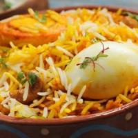 Egg Biryani · Egg omelette layered with basmati rice cooked with exotic spices. It is served with raita.