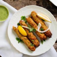 Chicken Seekh Kabab (4Pcs) · Minced chicken seasoned with chopped onions, herbs and spices, cooked on skewers in a tandoo...