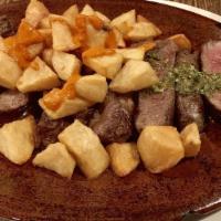 Chuletón / Rib Eye Steak · Asado, mojo verde, papas con romero. / Grilled, green mojo, potatoes with rosemary.