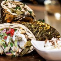 Chicken Shawarma · Roasted chicken marinated with special spices, thinly sliced and rolled in pita bread with g...
