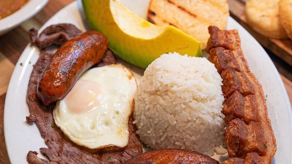 Bandeja Paisa · Meat (steak or ground beef) with pork rinds, egg, corn cake, sweet plantains, beans, colombian sausage and avocado.