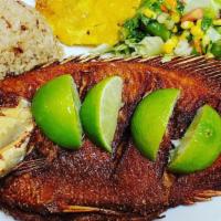 Mojarra Frita · Fried tilapia with rice, salad and one more side.