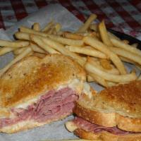 Reuben · Thinly sliced Corned Beef with Natural Swiss, sauerkraut and 1000 island dressing served on ...