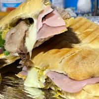 Cuban Sandwich · Slow roasted pork, ham, swiss cheese, pickles and mustard on Cuban bread.