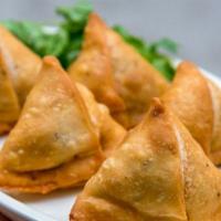 Vegetable Samosas (2) · Triangular puffed pastry stuffed with mashed potatoes, green peas, carrots and mildly spiced...