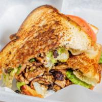 Jerk Chicken Sandwich · Choice of chicken or vegan crumbles on toasted artisan bread, topped with lettuce, tomato, a...